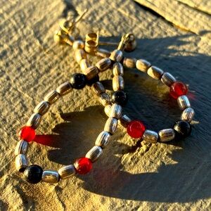 Sterling silver bead earrings with black and brownish red bead accents.